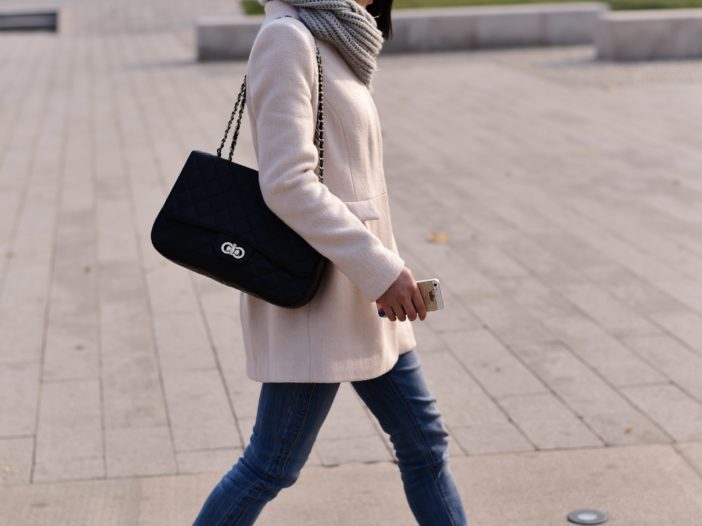 woman walking while holding smartphone