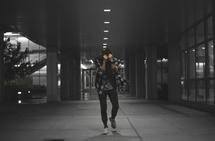 man standing near glass window