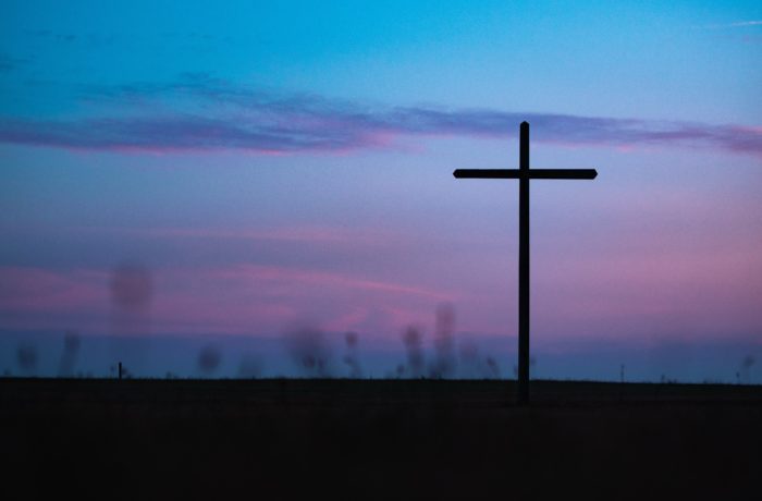 cross stand under purple and blue sky