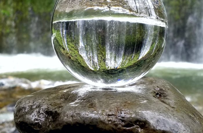 clear glass ball on brown rock