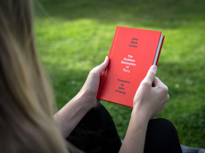 person holding red book during daytime