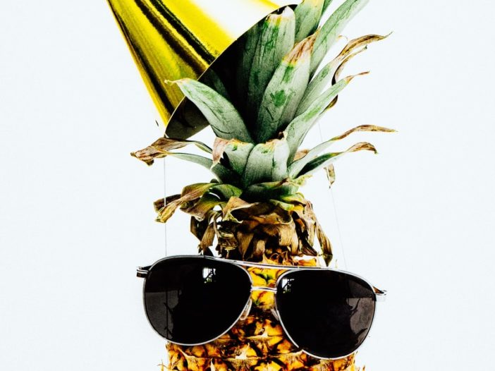 ripe pineapple with yellow cone and sunglasses