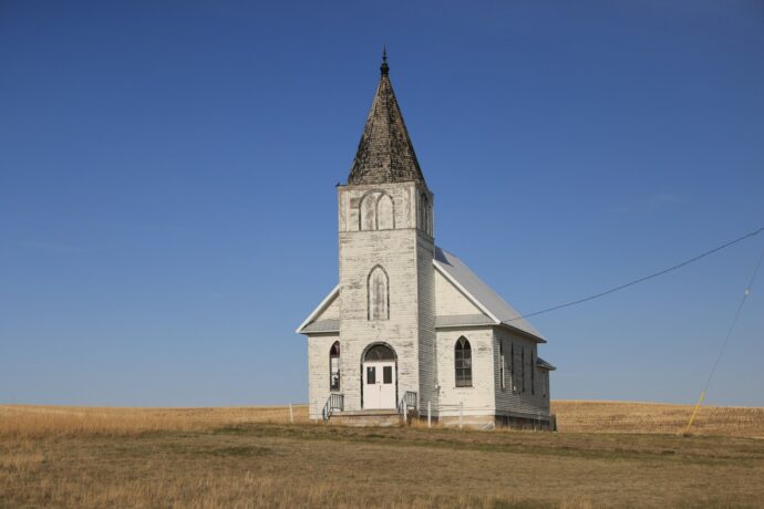 white and black concrete church under blue sky during daytime