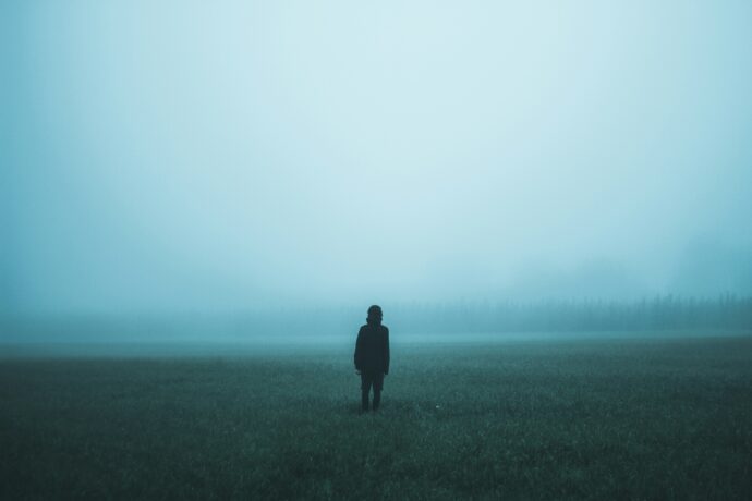 person standing in mist